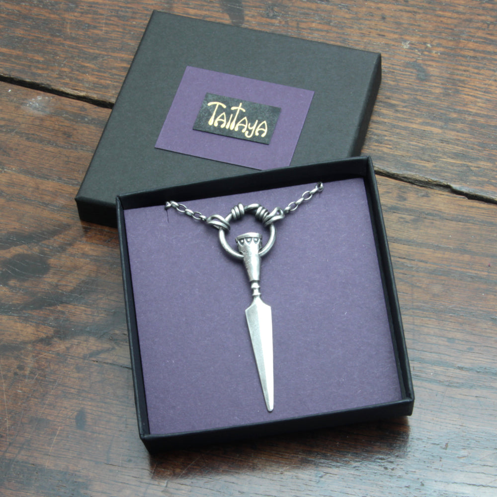 Silver spear pendant in a card gift box with gilded Taitaya Forge branding.