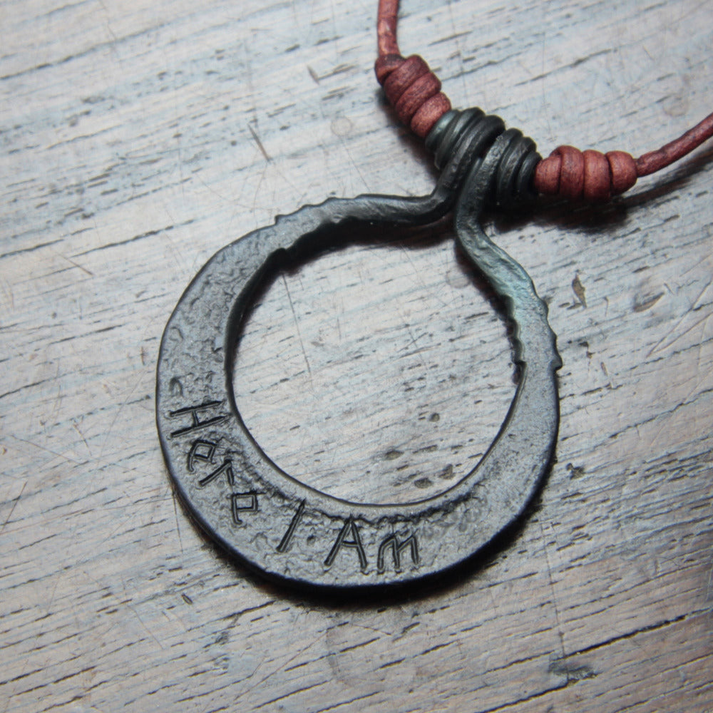 Hand engraved inscription "Here I am" on the back of the moon pendant, made and designed by Taitaya Forge