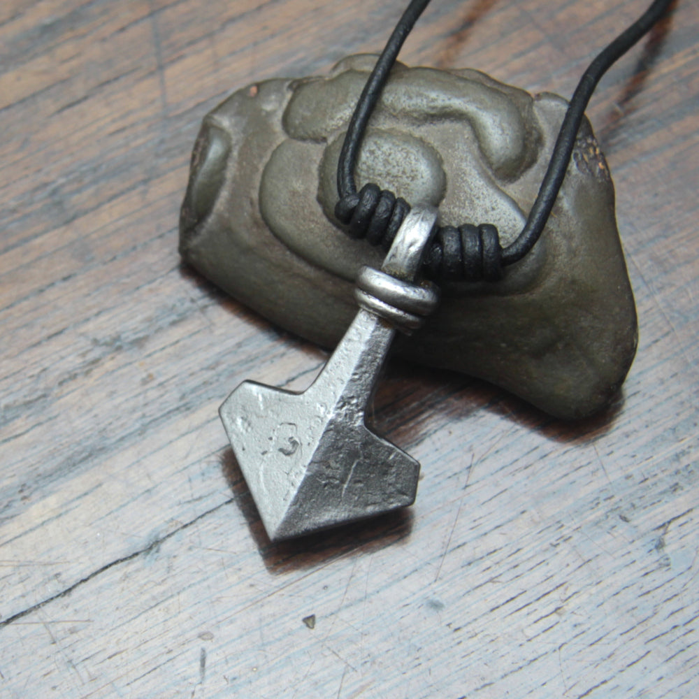 Silver coloured forged iron Thor's hammer pendant on a black leather cord. 